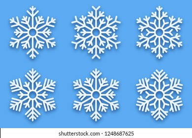 3D Vector Papercut Decorative Handmade Snowflakes Set with Soft Drop Shadow Isolated on Light Blue Background. Merry Christmas and Happy New Year Decoration Design Element