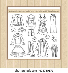 3-Vector set with hand drawn isolated doodles of clothes for women. Doodles on the theme of fashion and beauty. Sketches for use in design