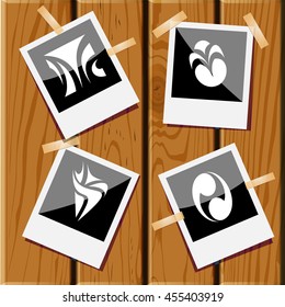 4 images of unique abstract forms. Photo frames on wooden desk. Vector icons set.