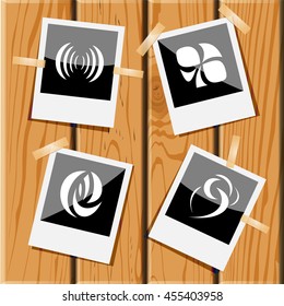 4 images of unique abstract forms. Photo frames on wooden desk. Vector icons set.