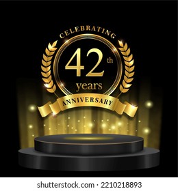 42th years golden anniversary logo celebration with ring ribbon and 3d podium. isolated on black background