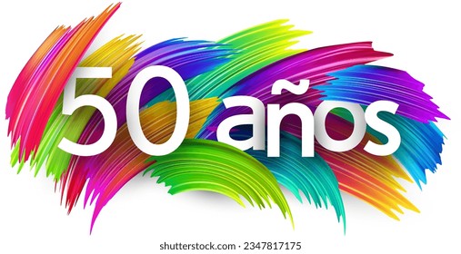 50 years at spanish paper word sign with colorful spectrum paint brush strokes over white. Vector illustration.
