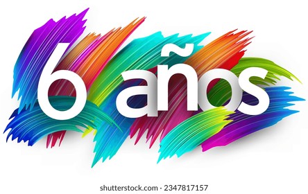 6 years at spanish paper word sign with colorful spectrum paint brush strokes over white. Vector illustration.