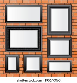 7 black frames over brick wall