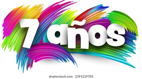 7 years at spanish paper word sign with colorful spectrum paint brush strokes over white. Vector illustration.