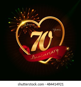 70 years anniversary logo golden colored,with love shape, red ribbon, and fireworks background