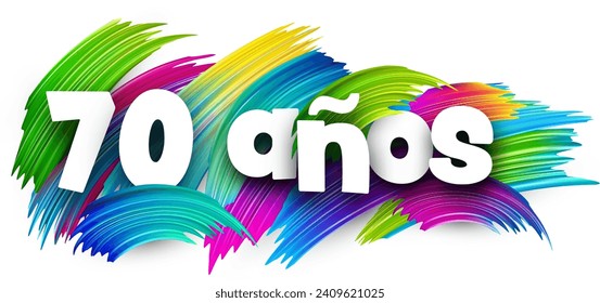 70 years at spanish paper word sign with colorful spectrum paint brush strokes over white. Vector illustration.