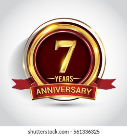 7th golden anniversary logo, seven years birthday celebration with ring and red ribbon isolated on white background