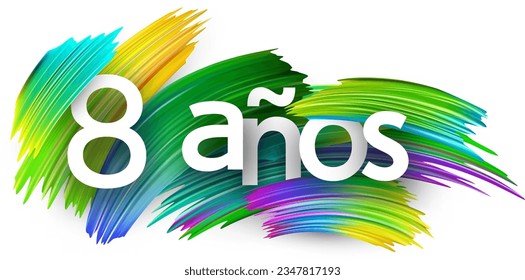 8 years at spanish paper word sign with colorful spectrum paint brush strokes over white. Vector illustration.