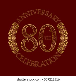 80th anniversary celebration vintage patterned logo symbol. Golden circular ornate emblem on red.