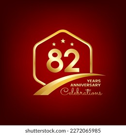 82 years anniversary inside of gold hexagon and curve with red backgrounds