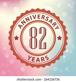 "82 Years Anniversary" - Retro style seal, with colorful bokeh background EPS 10 vector 