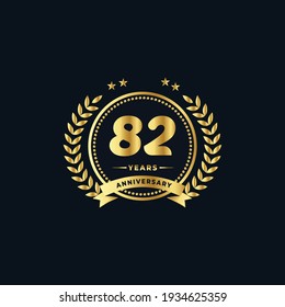 82th golden anniversary logo, with shiny ring and golden ribbon, laurel wreath isolated on navy blue background