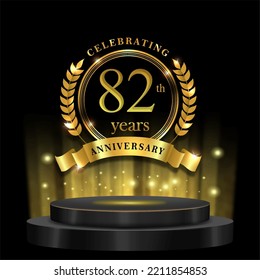 82th years golden anniversary logo celebration with ring ribbon and 3d podium. isolated on black background