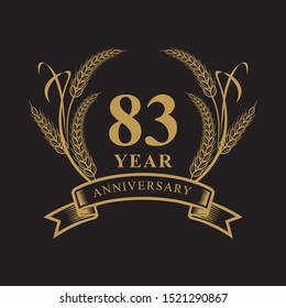 83 golden anniversary logo with ring and ribbon, laurel wreath vector design isolated on black background