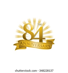 84th anniversary ribbon logo with golden rays of light