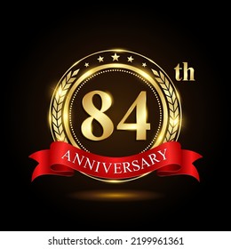 84th golden anniversary logo, with shiny ring and red ribbon, isolated on black background, vector design