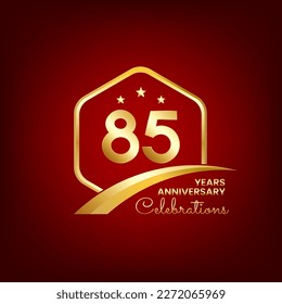 85 years anniversary inside of gold hexagon and curve with red backgrounds