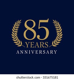 85 years old creative logotype. Congratulating 85th numbers gold colored template framed in palms. Isolated abstract graphic design template. Celebrating tradition banner.