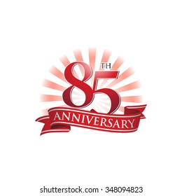 85th anniversary ribbon logo with red rays of light