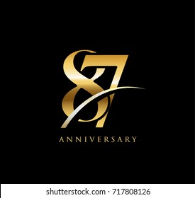 87 anniversary elegance gold logo. linked number with swoosh on black background