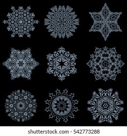 9 snowflakes set in abstract style. Freehand ethnic Xmas sketch. Ornamental artistic vector illustration on black background for Merry christmas cards. New Year 2017-2018 collection.