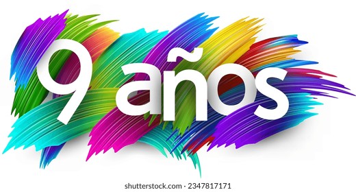 9 years at spanish paper word sign with colorful spectrum paint brush strokes over white. Vector illustration.