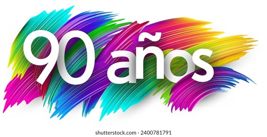 90 years at spanish paper word sign with colorful spectrum paint brush strokes over white. Vector illustration.