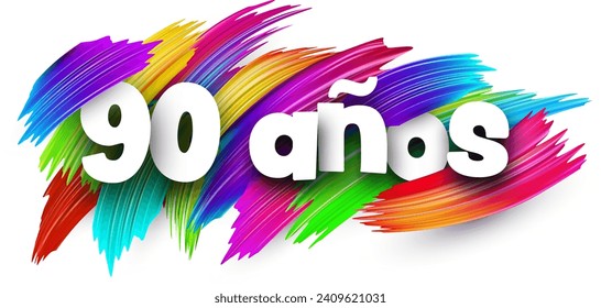 90 years at spanish paper word sign with colorful spectrum paint brush strokes over white. Vector illustration.