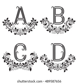 A, B, C, D vintage monograms in floral wreaths. Set of black letters in laurels.