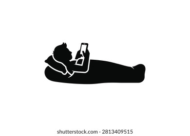['A simple black icon depicting a person lying down on a pillow while holding and looking at a mobile phone']
