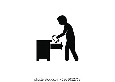 ['A simple black icon showing a person standing next to a cabinet and putting a mobile phone inside an open drawer']