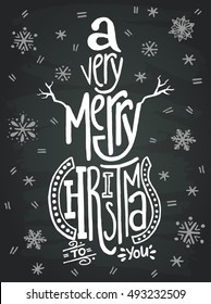 'A very merry Christmas' handwritten quote in a shape of a snowman on chalkboard background. Great design for invitation or greeting cards, posters, banners and holidays flyers.