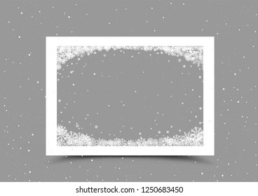 A4 paper frame with snow in corner on gray background. Christmas photo template