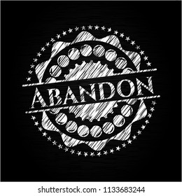 Abandon chalk emblem written on a blackboard