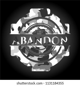 Abandon written on a grey camouflage texture