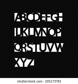 ABC set made of holes on a black bakground. 