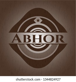 Abhor badge with wooden background