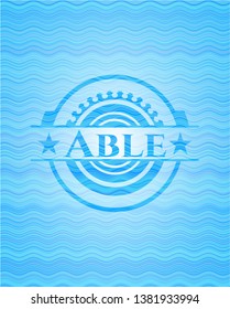 Able light blue water style badge.