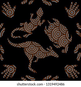 Aboriginal seamless vector pattern including ethnic Australian motive with kangaroo, lizard, turtle, palm, boomerang and other white and orange dotted typical elements on black background