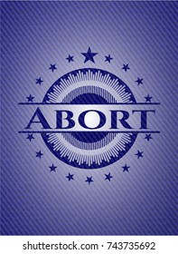 Abort badge with denim background