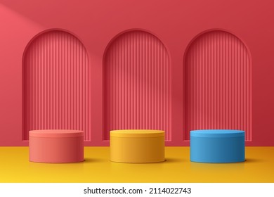 Abstract 3D room with realistic blue, yellow and red cylinder pedestal podium set on red arch door. Minimal scene for product display presentation. Vector geometric platform design. Stage for showcase