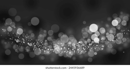 Abstract background in black and gray tones with many shiny sparkles, some of which are in focus and others are blurred, creating a captivating bokeh effect.