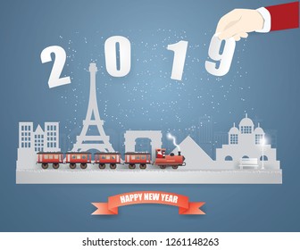 Abstract background card Happy new year and Merry Christmas 
with Santa Claus driving the train coming to France and hand  picked text 2019 on winter season  background,paper art and vector style  