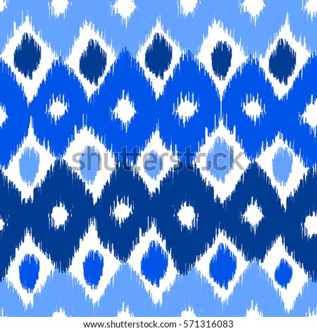 Abstract background. Colorful Ikat seamless pattern in blue colors for textile, wallpaper, card or wrapping paper.