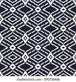 Abstract background in the ethnic style. Black and white Ikat seamless pattern for textile, wallpaper, card or wrapping paper.