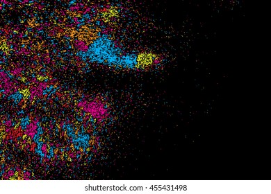 Abstract background, falling confetti. Many random tiny glitter pieces. Golden, red, blue and violet glitter Christmas random blow patterns. Abstract sparkle glittering background. Holiday texture. 