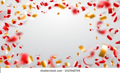 Abstract background of flying shiny confetti and pieces of serpentine, golden and red on white