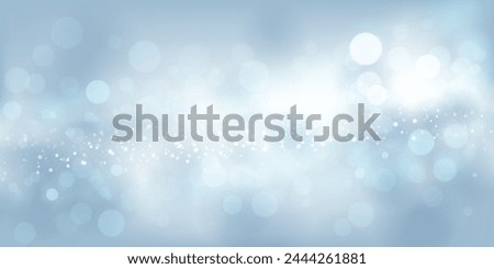 Abstract background in light blue tones with many shiny sparkles, some of which are in focus and others are blurred, creating a captivating bokeh effect.