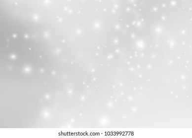 Abstract background with magic effect. Blurred defocused lights in white colors